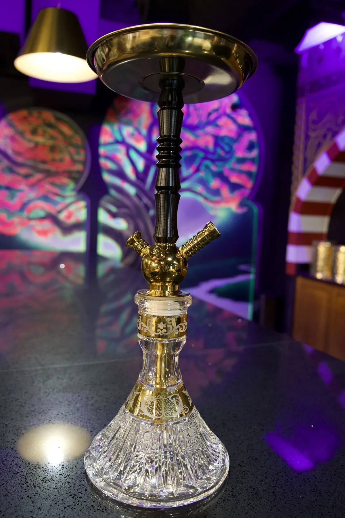 A glass hookah glowing purple